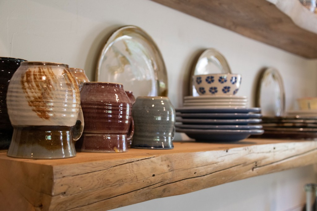 Dishes are beautifully displayed in the kitchen on these hand crafted shelves.