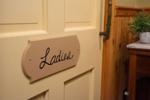 The restroom doors still have signs on them from the home's restaurant days. Little details that remind you of the home's history.